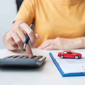 A Person With a Pen Using a Calculator