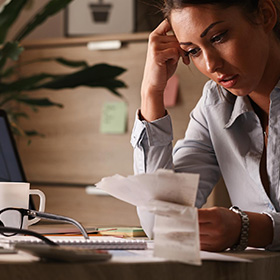 A Worried Woman Looking at Receipts